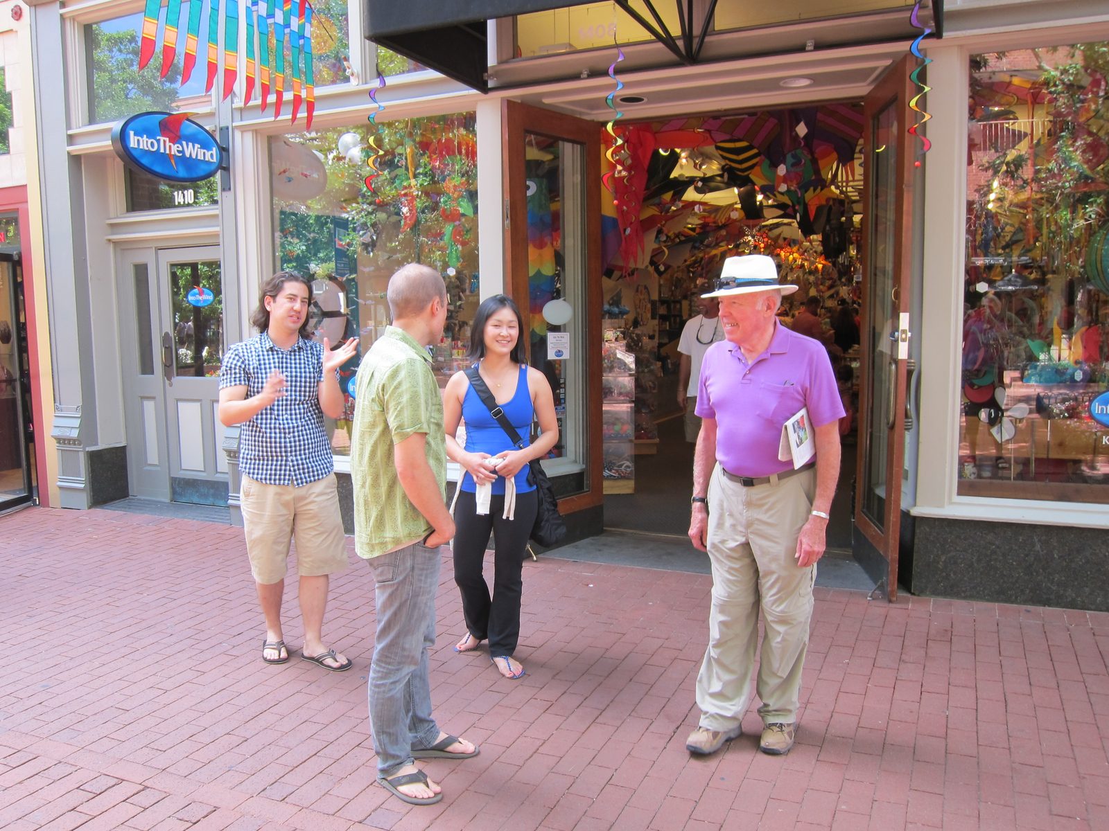 Jeff, Monica's cousin, discussing the stores on Pearl Street in Boulder to three willing...